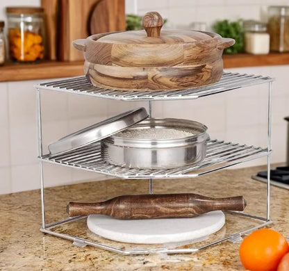 Metal kitchen organizer with wooden and metal items on a countertop