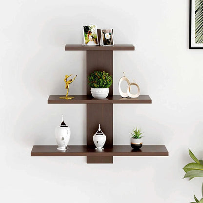 Wall-mounted brown shelf with decorative items against a white wall