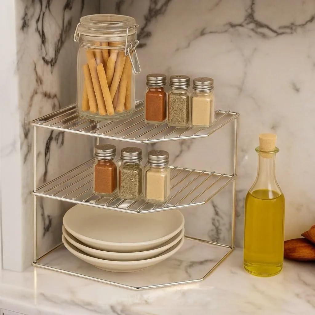 Three-tier metal shelf with jars, bottles, and plates on a marble countertop
